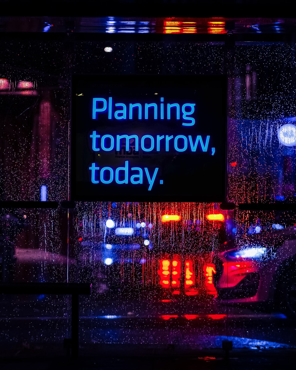 Neon sign reads "planning tomorrow, today."